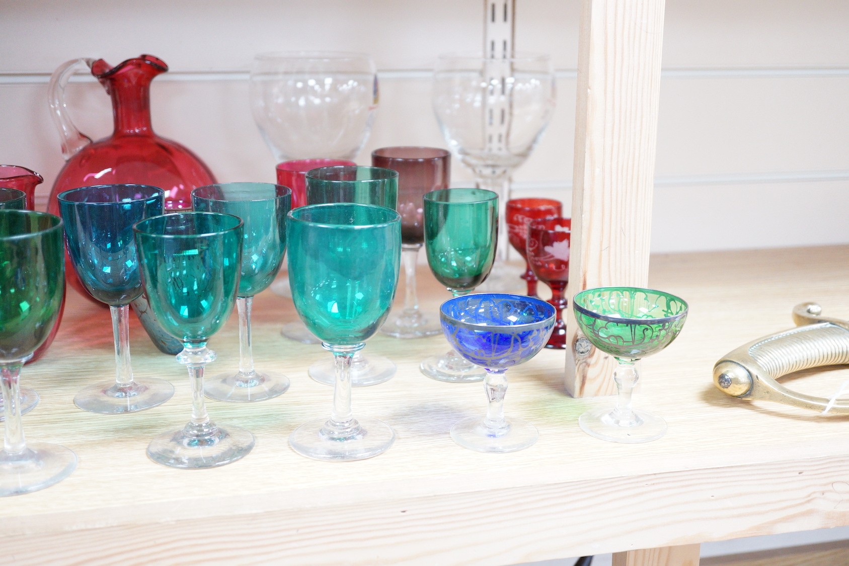 A quantity of cranberry glass, together with other coloured glassware and a Murano style fish ornament